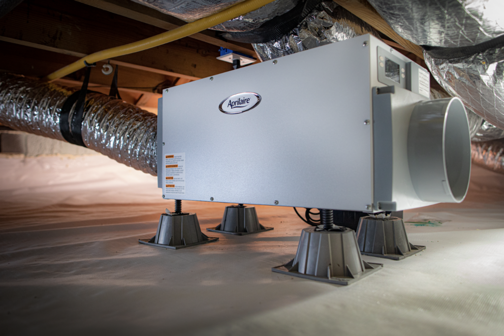 An AprilAire dehumidifier in an encapsulated crawlspace